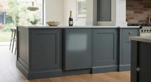 A seamless fully integrated wine fridge hidden behind a bespoke kitchen cabinet door in a modern UK home.