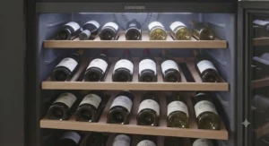 Interior view of a Liebherr wine fridge featuring high-quality wooden shelving for bottle organisation.