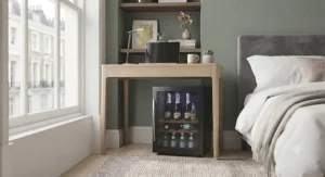 A portable mini wine cooler for bedroom work-from-home setups, placed conveniently next to a home office desk.