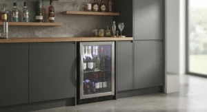 Slimline mini wine cooler fitting perfectly into a narrow gap in a contemporary home bar area