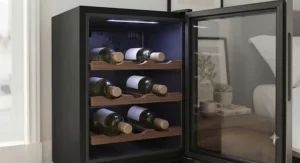 Close-up of a thermoelectric mini wine cooler for bedroom organisation, showing LED lighting and wooden shelving.