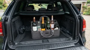 A packed wine carrier bag for 6 bottles securely loaded in the boot of a car ready for a weekend away.